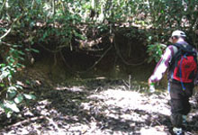 A member of the media inspecting the rhino's wallow